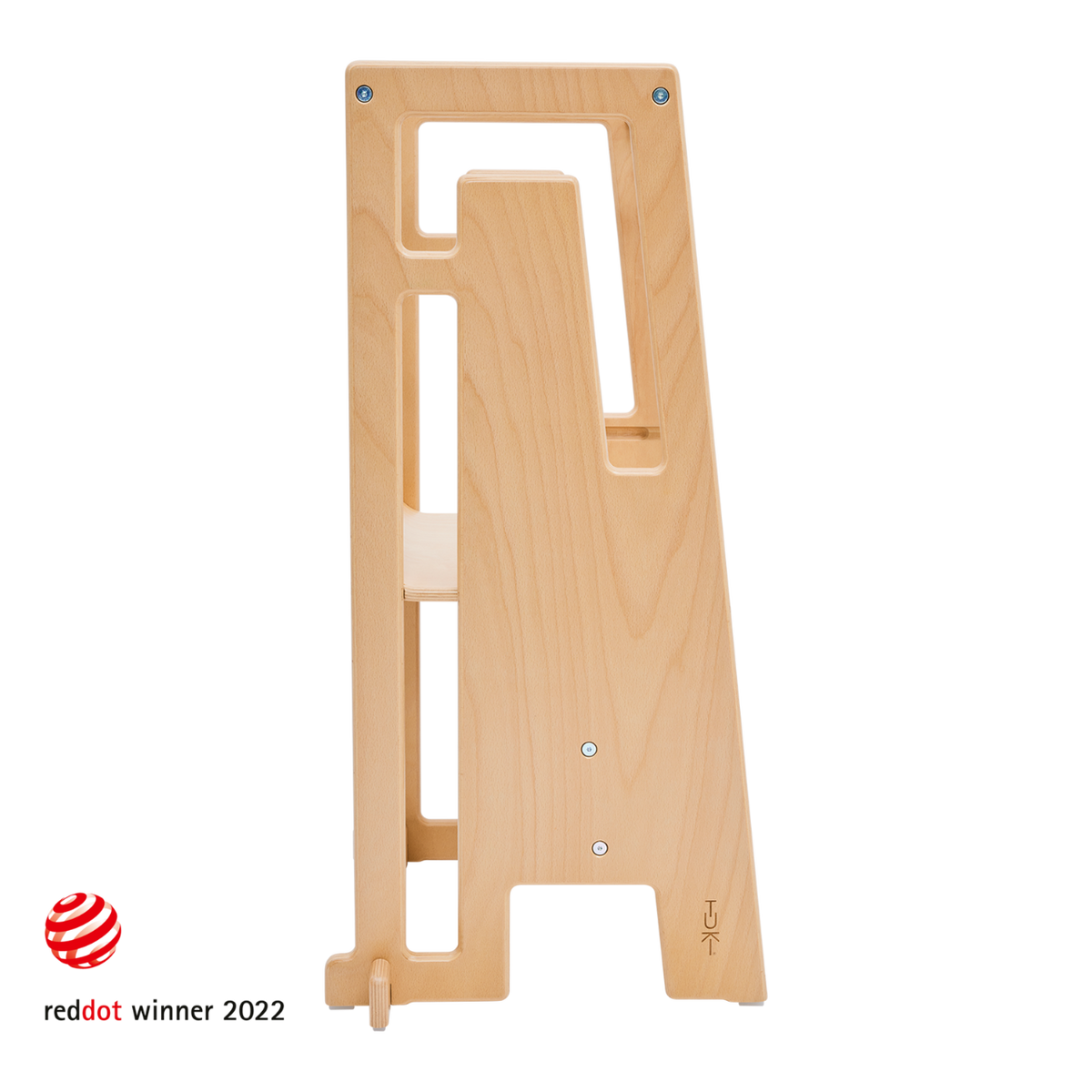 Child stands safely in the Tuki Learning Tower in the kitchen